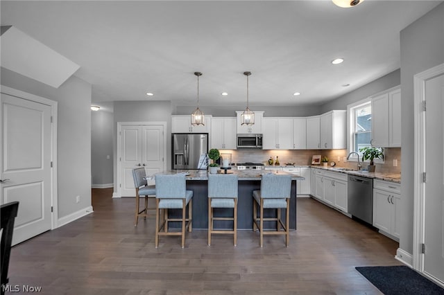 kitchen featuring appliances with stainless steel finishes, tasteful backsplash, and white cabinetry