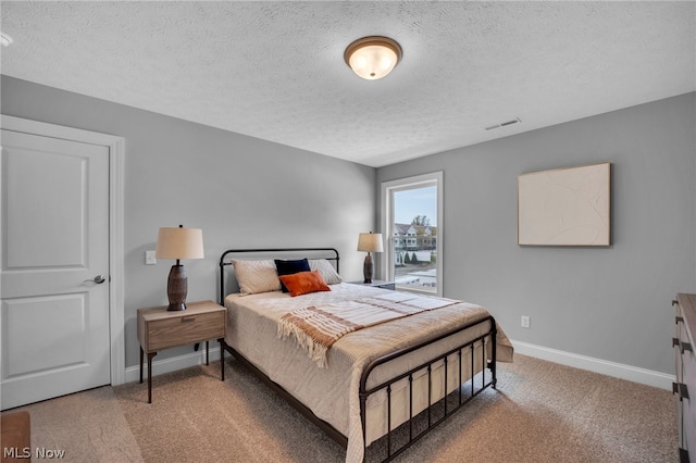 carpeted bedroom with a textured ceiling