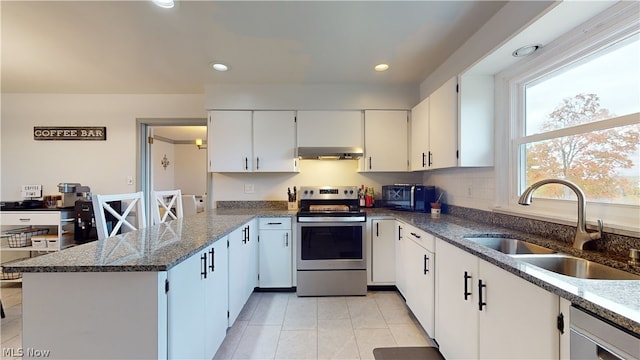 kitchen with sink, white cabinets, appliances with stainless steel finishes, extractor fan, and dark stone countertops