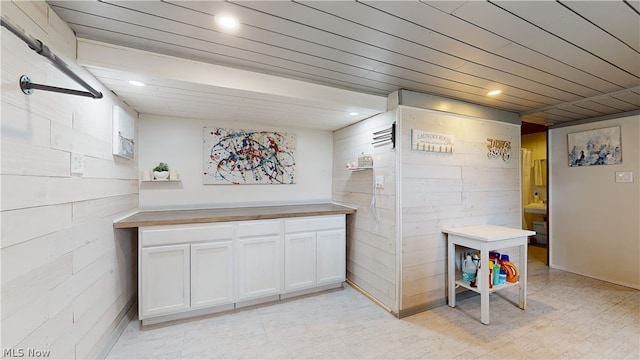 interior space featuring white cabinetry and wood counters