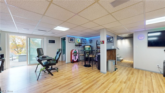 office featuring light wood-type flooring and a drop ceiling