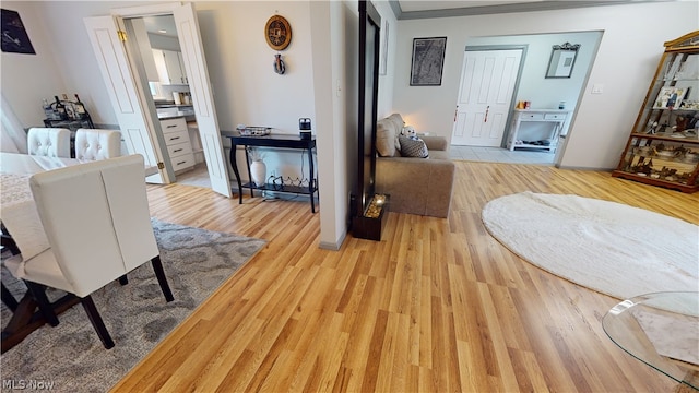 hall featuring light hardwood / wood-style flooring and ornamental molding