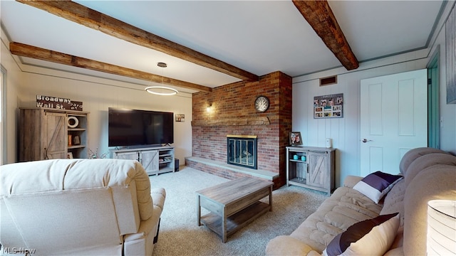 carpeted living room with a fireplace and beam ceiling