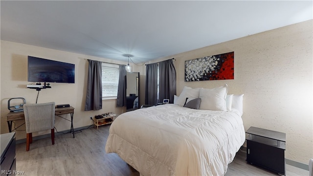 bedroom with wood-type flooring