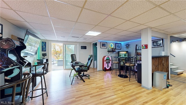 interior space featuring a drop ceiling and hardwood / wood-style floors