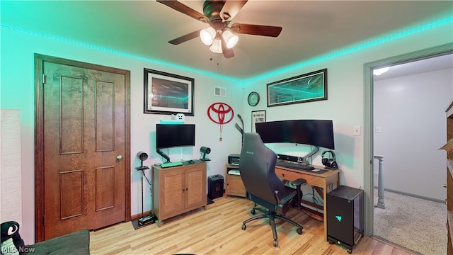 home office featuring ceiling fan and light hardwood / wood-style flooring