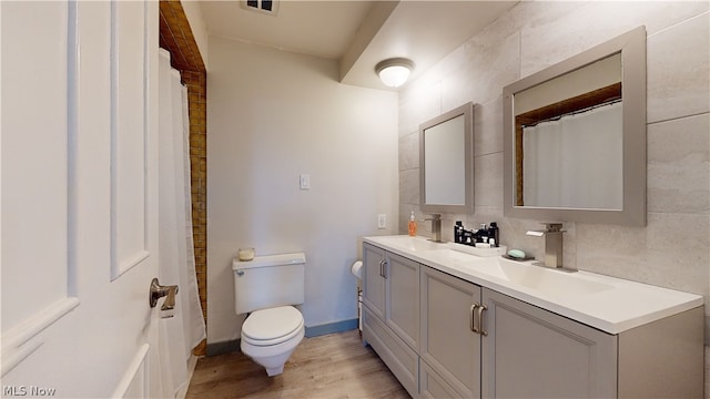 bathroom with hardwood / wood-style floors, vanity, and toilet