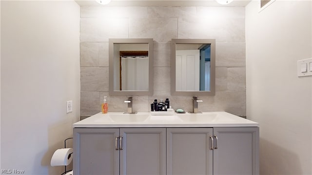 bathroom featuring tile walls, backsplash, and vanity