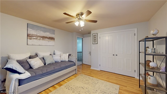 living room featuring ceiling fan and hardwood / wood-style flooring