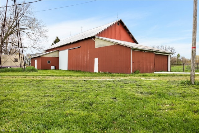 view of home's exterior featuring a lawn and an outdoor structure