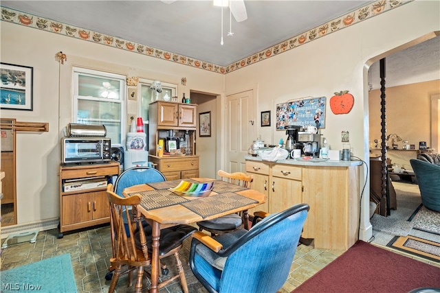 tiled dining room featuring ceiling fan