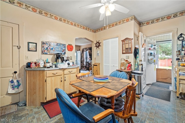 tiled dining space featuring ceiling fan