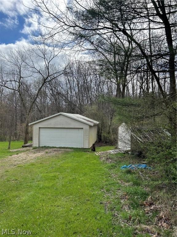 exterior space featuring a garage and a yard