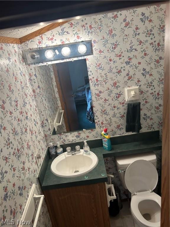 bathroom with vanity, tile patterned floors, and toilet