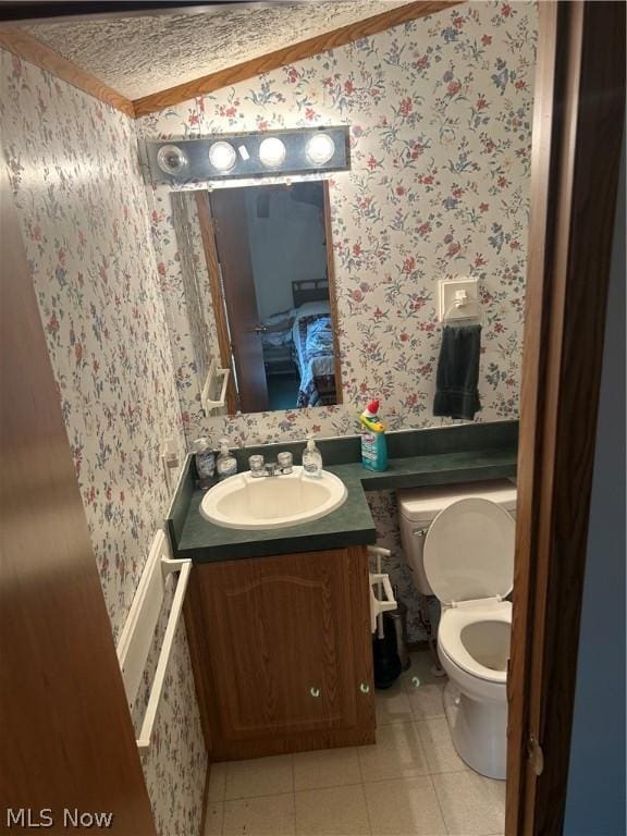 bathroom with tile patterned floors, vanity, and toilet