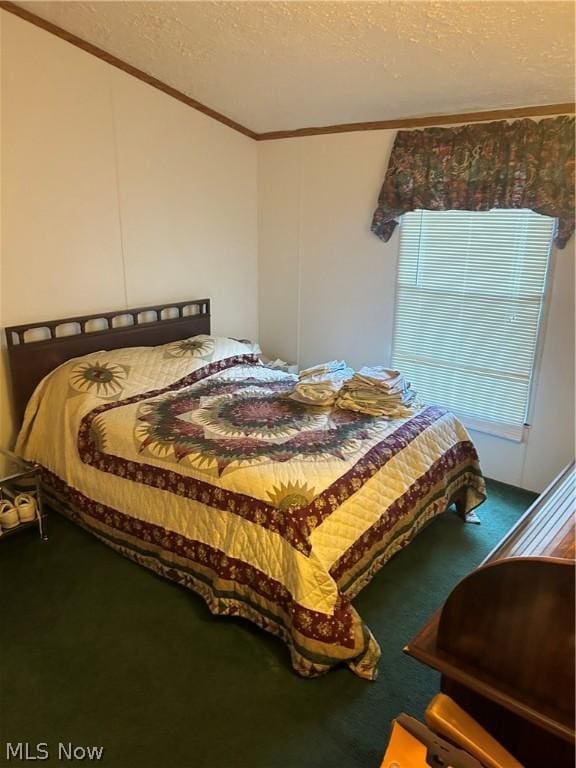 bedroom featuring ornamental molding, carpet, and a textured ceiling