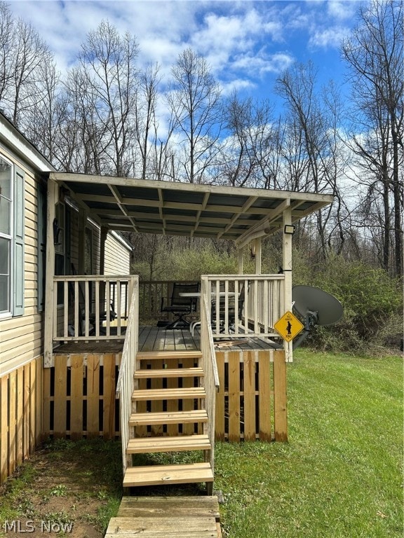 wooden deck featuring a yard