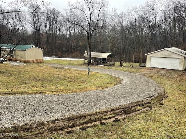 view of yard with a garage and an outdoor structure