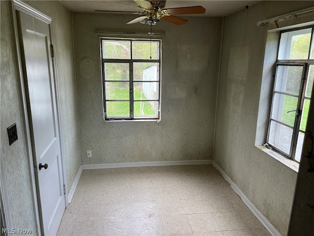 spare room with ceiling fan and tile flooring