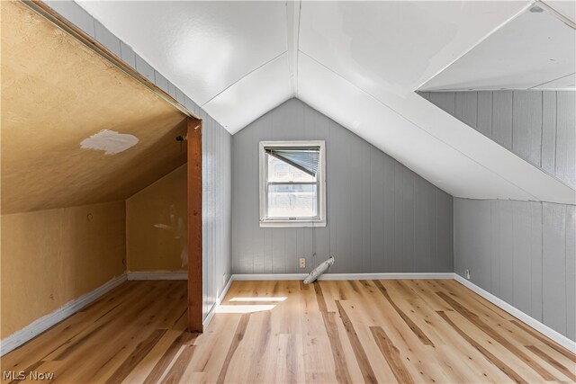 bonus room with lofted ceiling and light hardwood / wood-style floors