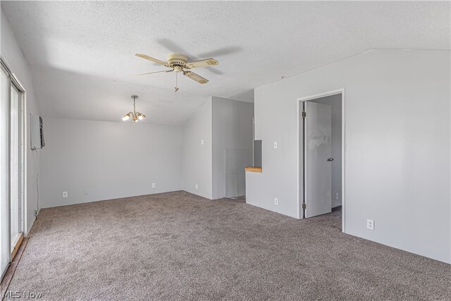 carpeted spare room featuring ceiling fan with notable chandelier, a textured ceiling, and lofted ceiling