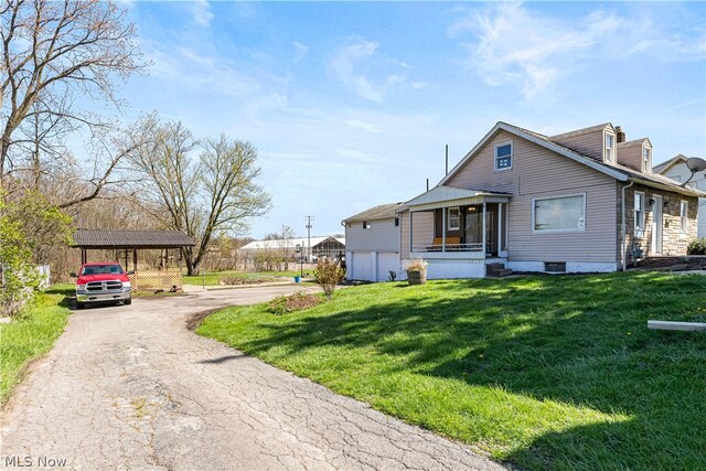 view of front of house with a garage, a carport, and a front yard