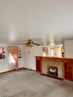 unfurnished living room with ceiling fan, carpet flooring, and a fireplace