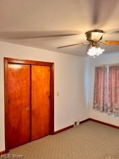 interior space featuring a closet, ceiling fan, and carpet flooring