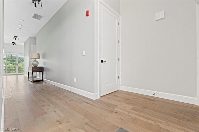 corridor with light hardwood / wood-style flooring