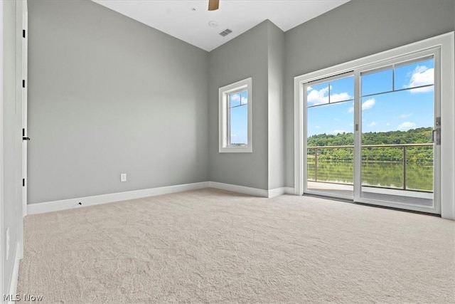 carpeted spare room featuring ceiling fan