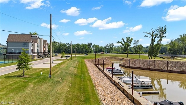 exterior space featuring a boat dock and a yard