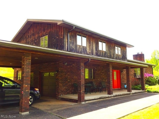 11421 Clay Rd, Newton, WV 25266 - view of front facade featuring a porch, brick siding, board and batten siding, and a chimney
