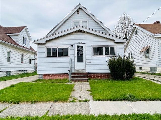 bungalow-style home featuring a front yard