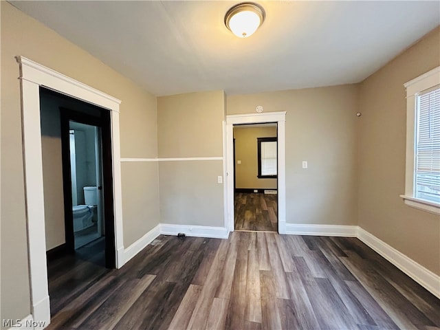 unfurnished room featuring dark hardwood / wood-style flooring