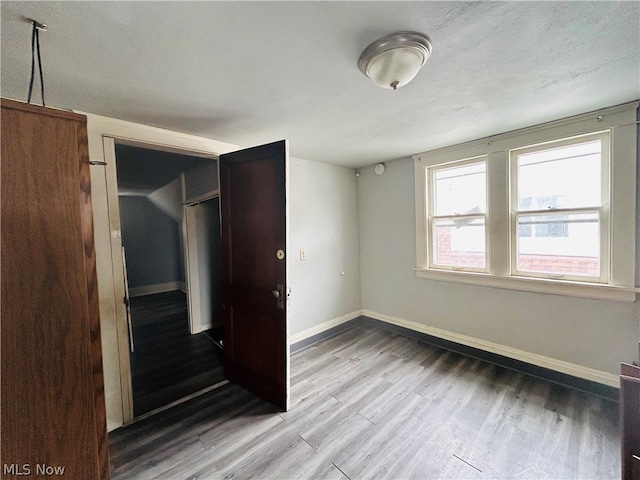 unfurnished bedroom with a closet and hardwood / wood-style floors