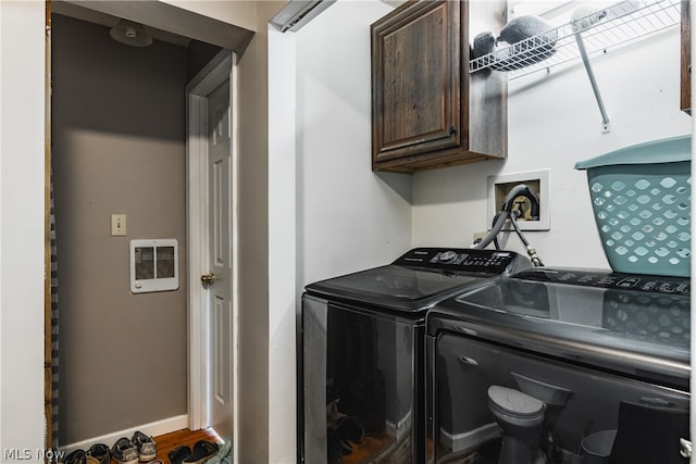 laundry area featuring washer hookup, washing machine and dryer, and cabinets