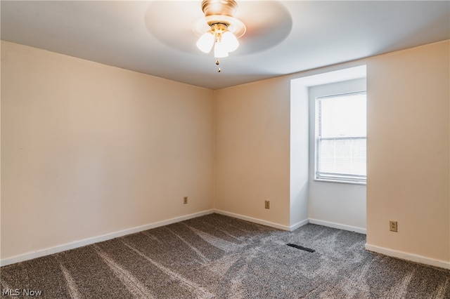 carpeted spare room featuring ceiling fan