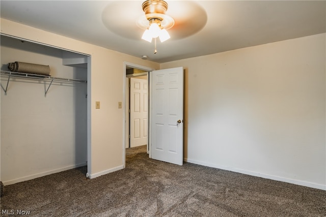 unfurnished bedroom with a closet, dark colored carpet, and ceiling fan