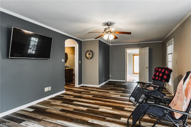 sitting room with ornamental molding, dark hardwood / wood-style flooring, and ceiling fan