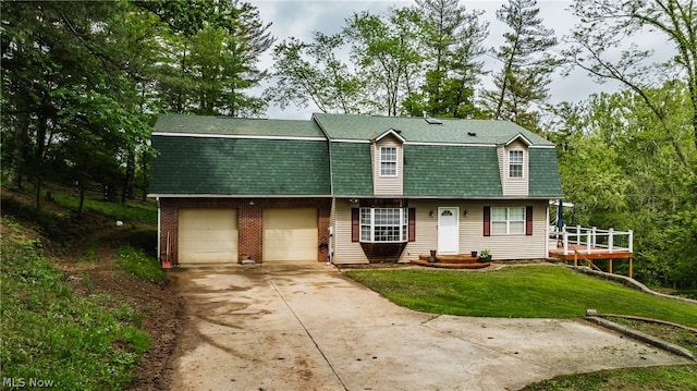 view of front of house featuring a garage and a front lawn