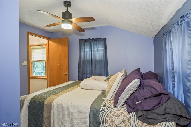 bedroom featuring a textured ceiling, ceiling fan, and vaulted ceiling