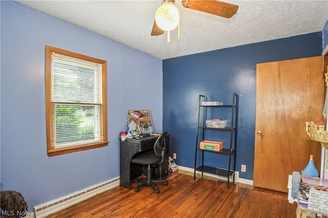 office with a textured ceiling, ceiling fan, dark hardwood / wood-style flooring, and baseboard heating