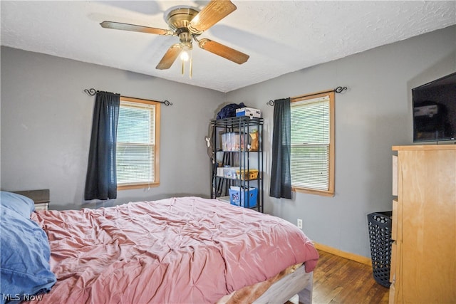 bedroom featuring hardwood / wood-style flooring and ceiling fan