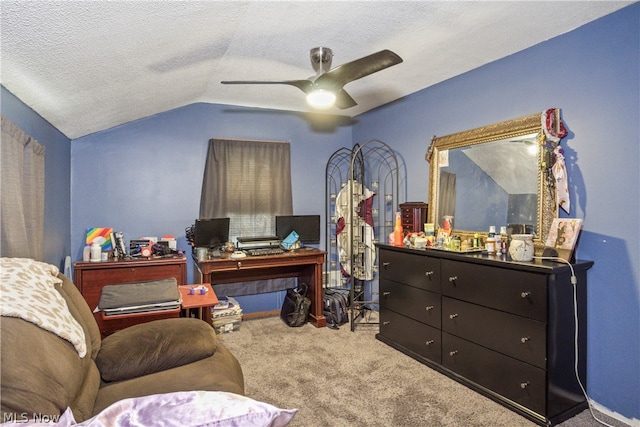 carpeted office with lofted ceiling, ceiling fan, and a textured ceiling