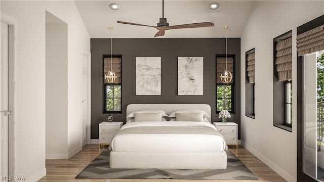 bedroom featuring ceiling fan, light hardwood / wood-style floors, and lofted ceiling