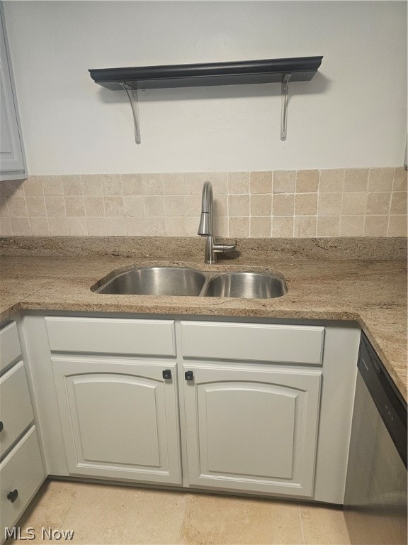 kitchen with sink, dishwasher, tasteful backsplash, and light tile floors