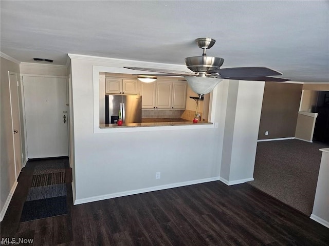 kitchen with cream cabinetry, dark hardwood / wood-style floors, ceiling fan, and stainless steel fridge