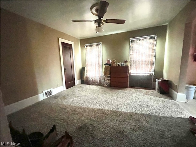 unfurnished bedroom with ceiling fan and carpet flooring