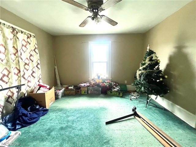 misc room with ceiling fan and carpet floors