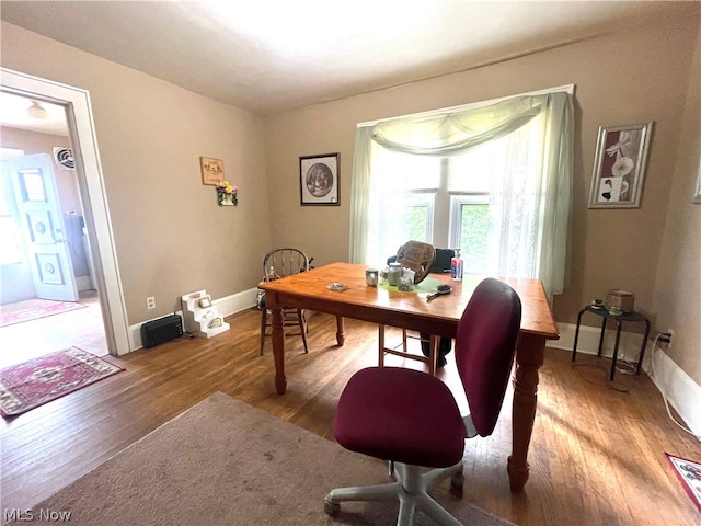 home office with hardwood / wood-style flooring